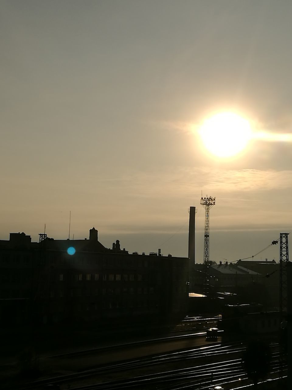 sun, sunset, built structure, architecture, silhouette, building exterior, sunlight, sky, city, industry, bright, cloud - sky, outdoors, tall - high, lens flare, spire, no people, progress