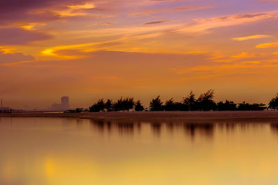 Scenic view of lake against orange sky