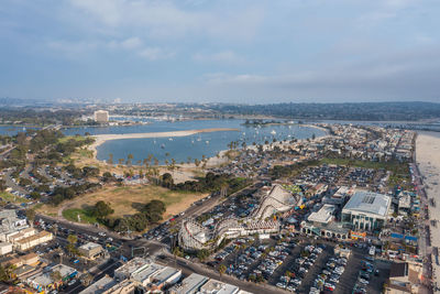 High angle view of buildings by sea against sky