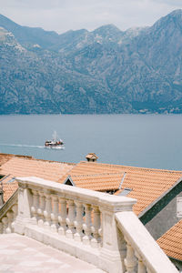 Scenic view of sea and mountains against sky