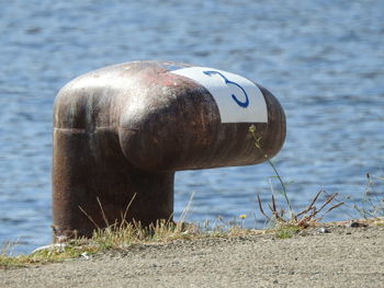 Close-up of wooden post at lakeshore