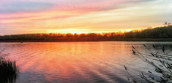 Scenic view of lake against romantic sky at sunset