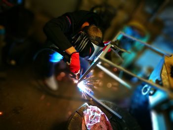 High angle view of welder welding in workshop