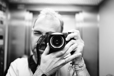 Side view of woman photographing with camera