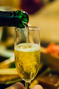 Close-up of beer pouring in glass