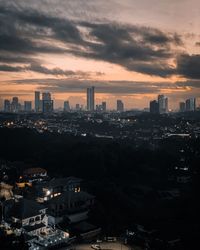 High angle view of illuminated buildings against sky during sunset