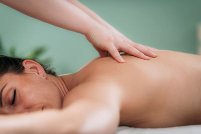 Relax massage for shoulders and neck, hands of a massage therapist massaging shoulder of a female