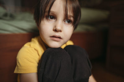 Sad boy sitting at home