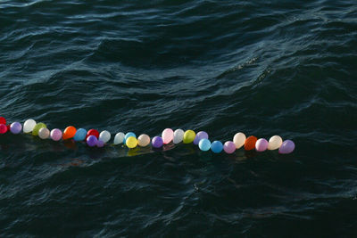 High angle view of multi colored balloons in sea