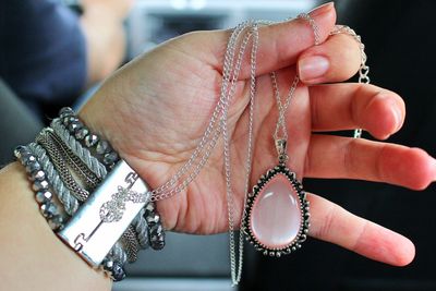 Close-up of hand holding jewelry 