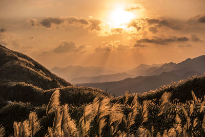 Scenic view of mountains against sky during sunset