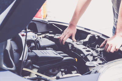 Cropped image of person repairing car