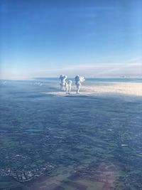 Scenic view of snow covered land against sky