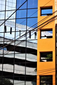 Low angle view of modern building against blue sky