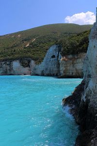 Scenic view of sea and rock formation against sky