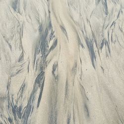 Full frame shot of tire tracks on sand