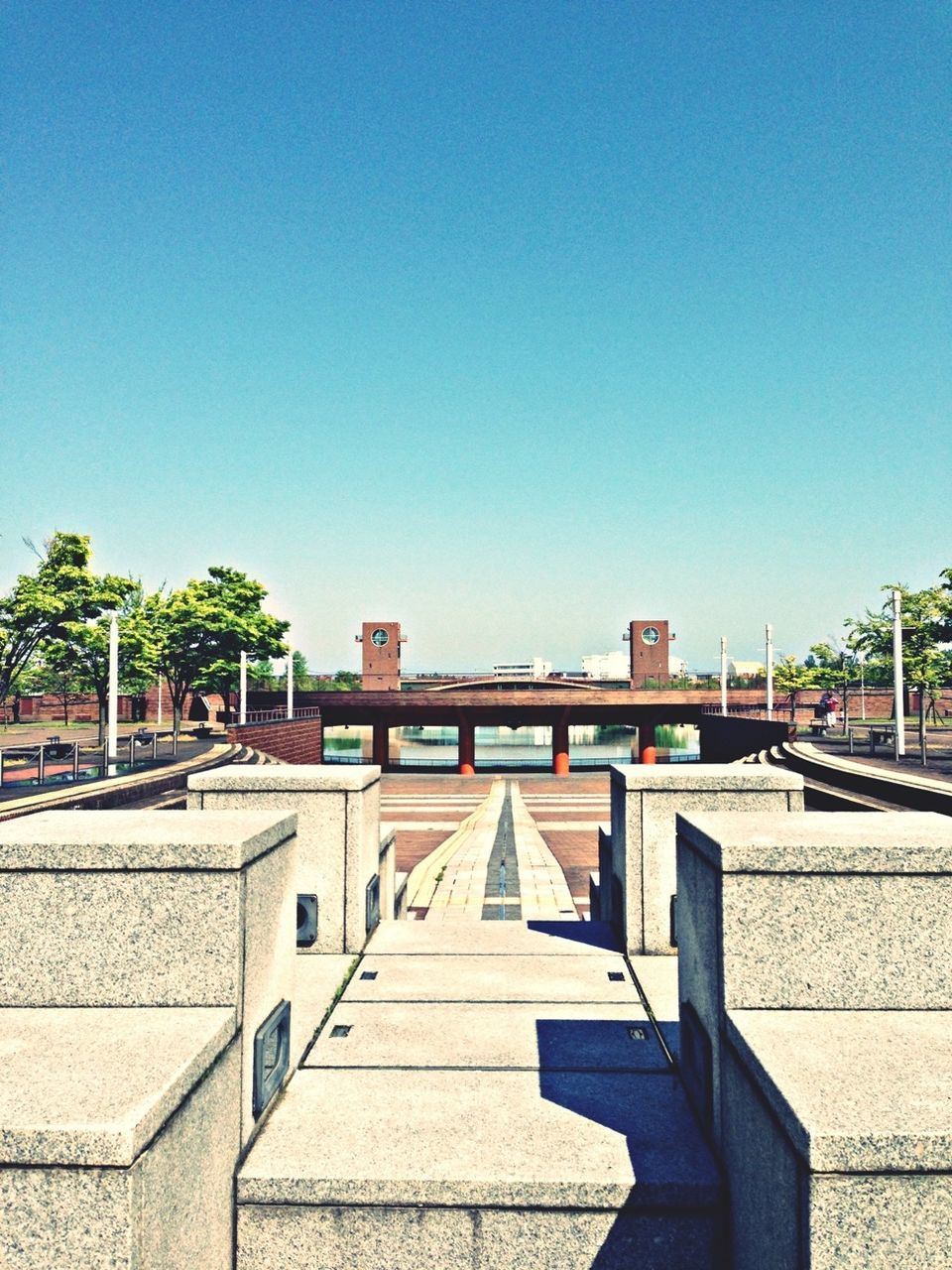 clear sky, architecture, built structure, building exterior, copy space, blue, the way forward, sunlight, railing, city, shadow, day, walkway, outdoors, tree, steps, empty, no people, residential structure, house