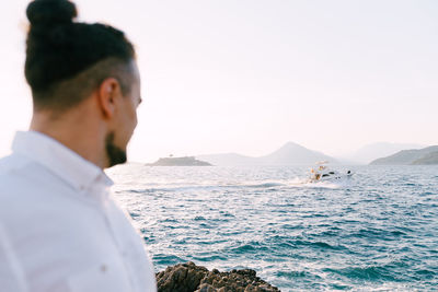 Man in sea against clear sky