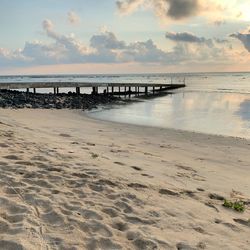 Scenic view of beach against sky during sunset