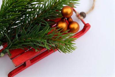 High angle view of christmas decoration with sled on white background