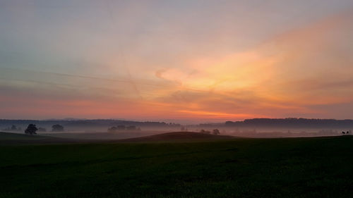 Scenic view of landscape against sky during sunset