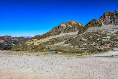 Scenic view of mountains against clear blue sky