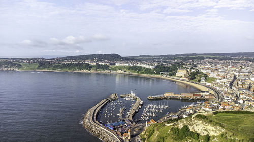 Drone shot of scarborough south bay beach and harbor in the distance 
