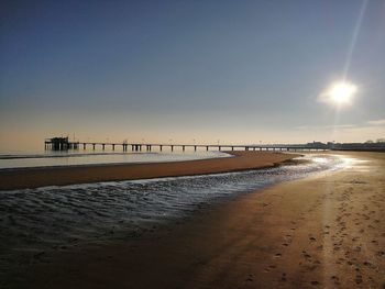 Scenic view of beach against sky during sunset