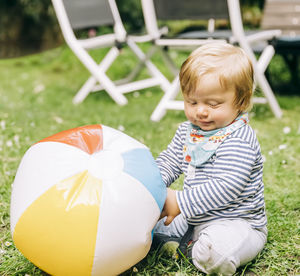 Cute boy sitting on grass