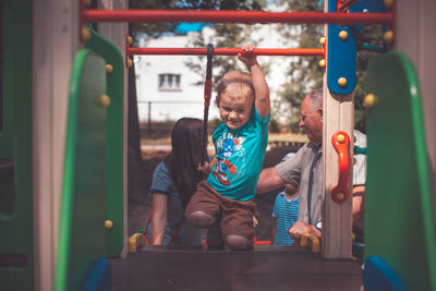 Full length of boys on slide at playground