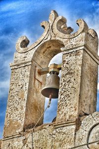 Low angle view of bell tower against sky