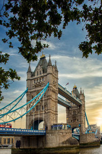 Low angle view of bridge against cloudy sky