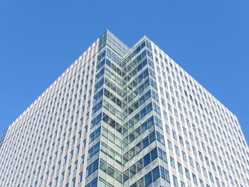 Low angle view of modern buildings against clear blue sky