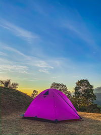 Scenic view of tent on field against sky