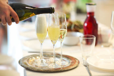 Midsection of wine in glass on table