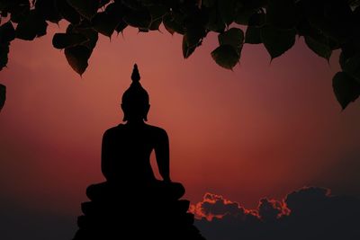 Low angle view of silhouette statue against sky during sunset