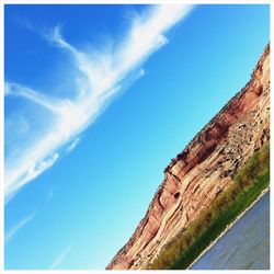 Low angle view of mountain against blue sky