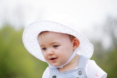 Close-up of cute baby girl wearing hat