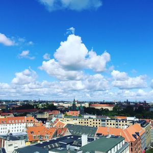 High angle view of cityscape against blue sky