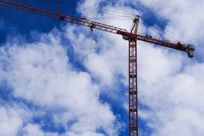 Low angle view of crane against sky