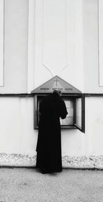 Man standing in front of built structure