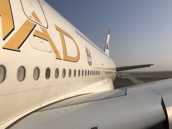 Airplane on runway against clear sky