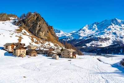 View of the village of grevasalvas, and lake sils, in engadine, switzerland, in winter.