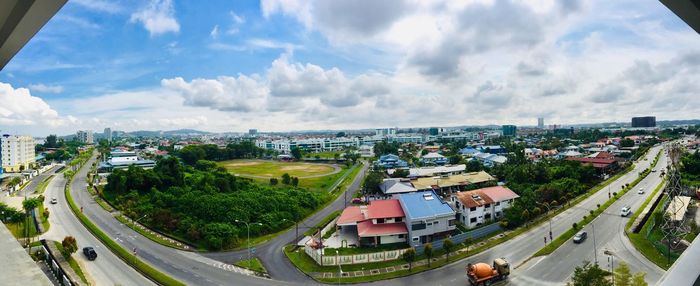 High angle view of street amidst buildings against sky