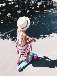 High angle view of girl riding push scooter on road