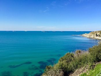 Scenic view of sea against blue sky