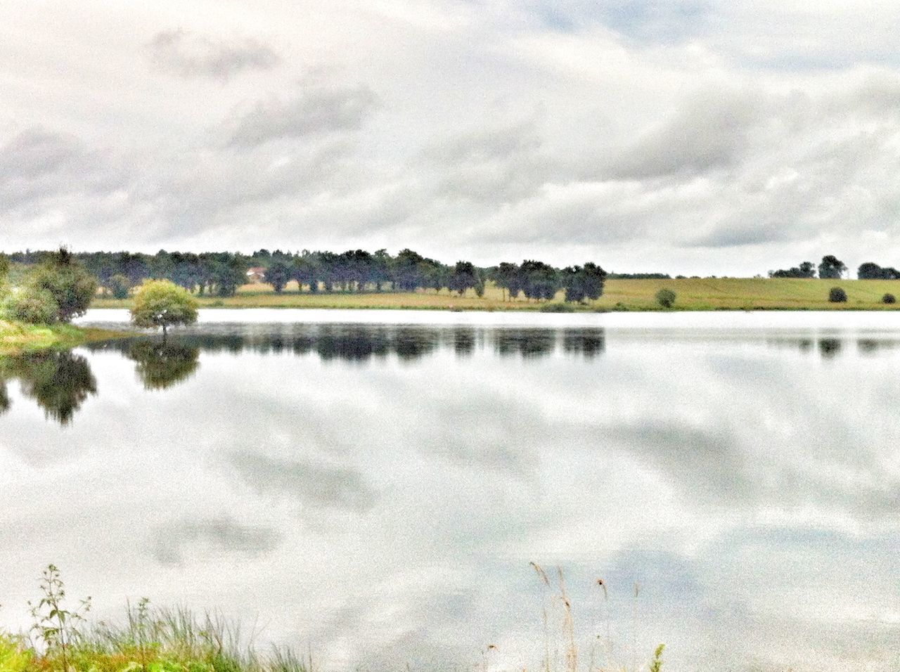 sky, cloud - sky, water, tranquil scene, tranquility, lake, tree, scenics, cloudy, beauty in nature, reflection, cloud, nature, idyllic, landscape, waterfront, outdoors, weather, calm, day