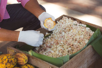 Midsection of man preparing food at market stall