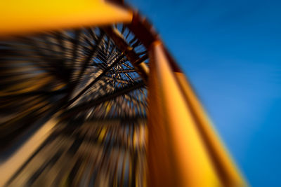 Low angle view of ferris wheel against blue sky