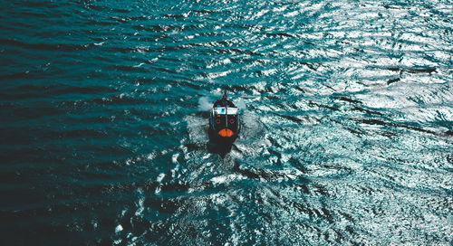 High angle view of people on boat in sea